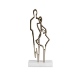 Metallic sculpture of a couple on a white base against a white background