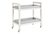 White baby changing table with gray cushion on a white background