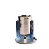 A modern cocktail ice bucket featuring a brushed silver stainless steel body and dual blue marbled resin side supports on a matching round base, set against a plain white background.