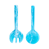 Two blue marbled salad servers on a white background