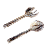 Two wooden salad servers with a natural grain pattern on a white background