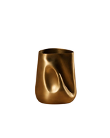 Bronze vase with wavy design on a white background