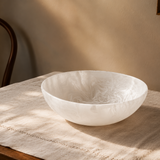 White ceramic bowl on a textured surface with a neutral background
