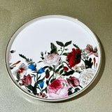 Round decorative plate with floral design on a beige background